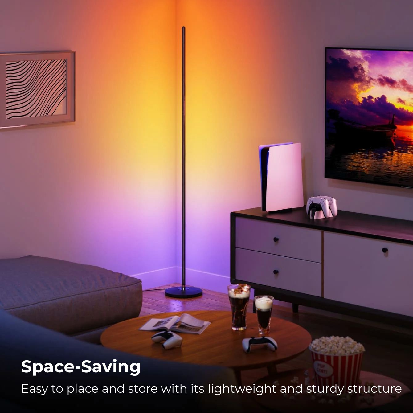 Smart Govee floor lamp with RGBIC colors and app control by Apex Light India , Living room with a colorful floor lamp and a TV displaying a sunset 